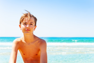 Teenage boy with wistful look against seascape