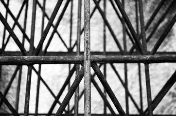 Abstract photography in black and white of a composition of lines perpendicular and parallel to each other, in a construction