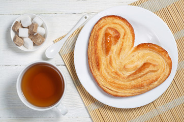 Cookie in the shape of a heart and tea