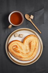 Cookie in the shape of a heart and tea