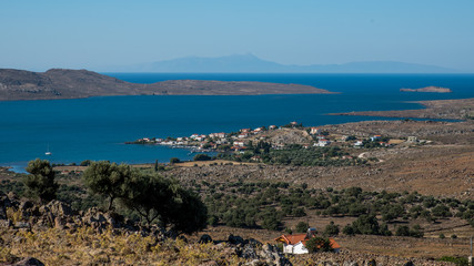 Greek village on the aegean sea with islands in the background