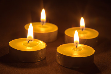 Fototapeta na wymiar Group of burning candles on black background