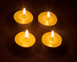 Group of burning candles on black background