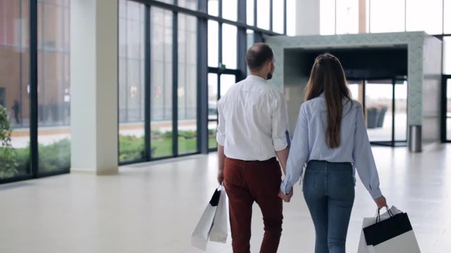 Couple walking through the mall. shopping theme