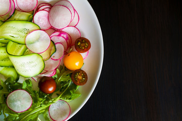 Salad bowl on dark.