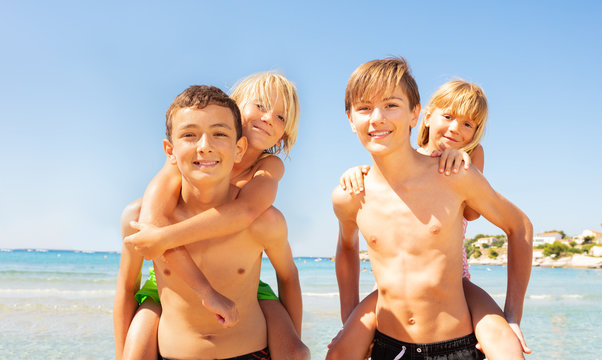 Boys giving their little friends piggyback rides - Powered by Adobe