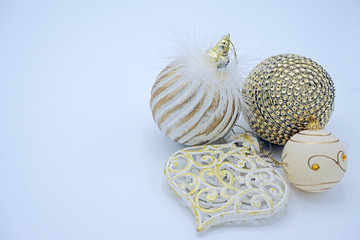 Traditional  white and gold Christmas ornaments. Heart, ball and feathers isolated on white background with copy space.      