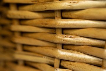 A part of a braided brown basket from wood