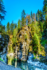 Obraz premium The Coquihalla River before it flows through Coquihalla Canyon Provincial Park and past the Othello Tunnels of the old Kettle Valley Railway near the town of Hope, British Columbia, Canada 