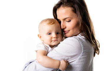 Fototapeta na wymiar A mother holdng his baby on studio white background