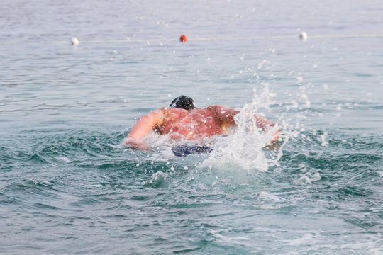 Swimmer dives into the depths of the sea. Background