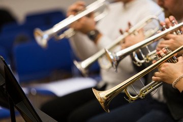 People playing the trumpet during rehearsal