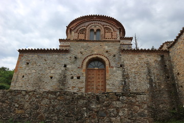 Fototapeta na wymiar Entrance to medieval greek church in the ruins of abandoned ancient city of Mystras, Peloponnese, Greece