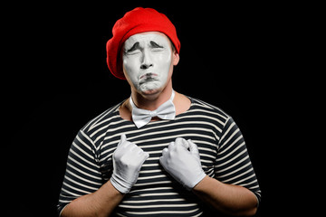 Crying male mime on black