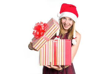 Cheerful woman with a gift box in the hat of Santa Claus. New Year shopping. Christmas gift is a surprise.