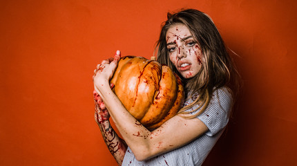 Portrait of a woman with make up blood on her face. Halloween sexy student girl in blood with...