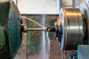 Grinding parts on the machine with water. Side view.