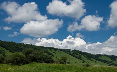 Fototapeta na wymiar Beautiful mountain landscape and meadows with nice blue sky and cloud on summer sunny day