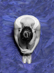 Aerial view of a unrecognizable ballet dancer sitting on floor