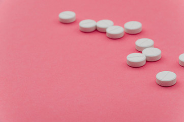 Close-up of tablets on pink background