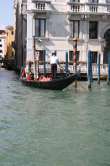 Fototapeta na wymiar Gondola on canal in Venice, buildings in background Italy