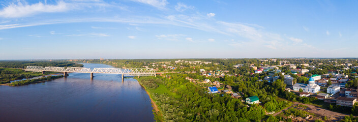 a panorama from a height, a typical small city in central Russia and the river Vyatka with railroad bridge