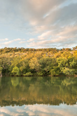 Beautiful tree lined view of the sunset reflection on the lake