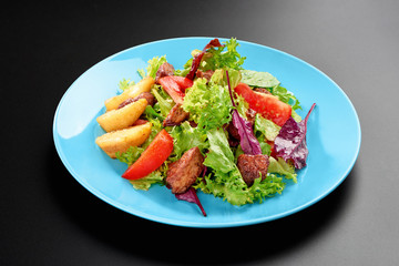 Salad cherry tomatoes leaves greens chicken breast basil Concept healthy meal black background menu restaurant