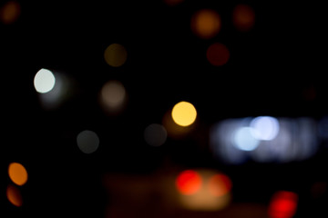 Colorful defocused bokeh lights background. Festive background with natural bokeh. Abstract blur background.