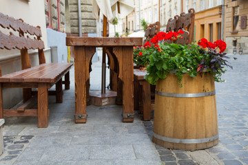 Fototapeta na wymiar Decorative barrel with flowers in Lviv