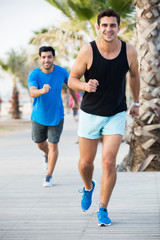 Portrait of adult man who is jogging with friend