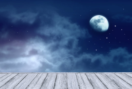 Background of night sky with mysterious clouds, moon, stars and table in shabby chic style. Moon is taken by me with my camera.