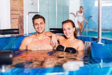 Couple relaxing in spa pool