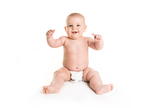 Infant child baby boy toddler naked in diaper looking at the camera isolated on a white background