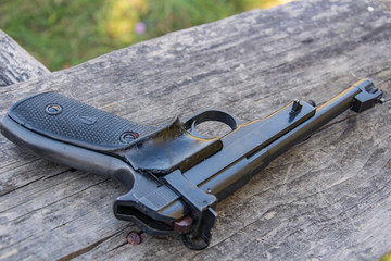 Margolin Pistol on the old table, close-up