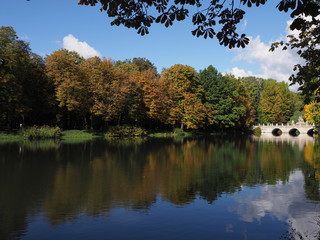 Fototapeta na wymiar Beautiful white bridge in baths park landscapes in Warsaw, european capital city of Poland in 2018 on September