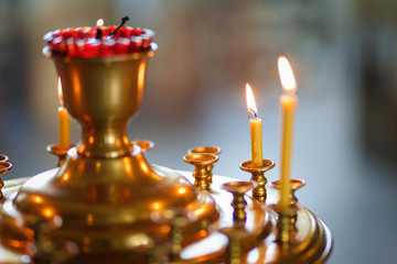 Burning candles on a stand in the Church.