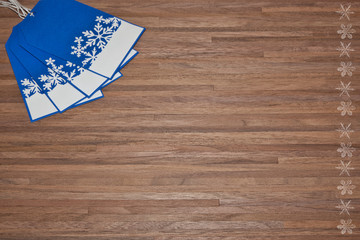 blue tags with snowflakes on wood surface