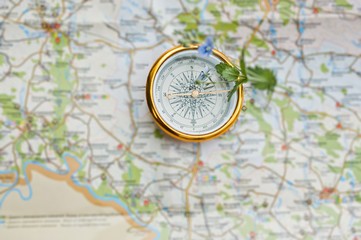 Close-up photo of compass laying on the map.