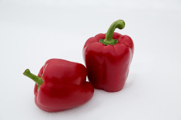 Paprika. Red bell pepper on white snow.
