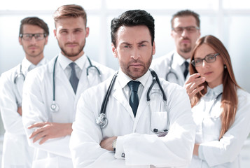 portrait of doctor and medical staff standing in the office