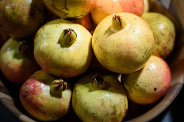 fresh organic pomegranates in basket , still life