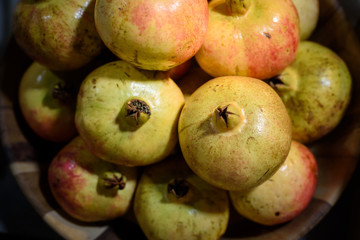 fresh organic pomegranates in basket , still life