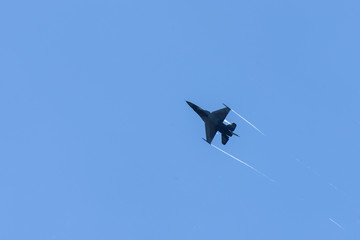 Military aircraft flying over blue