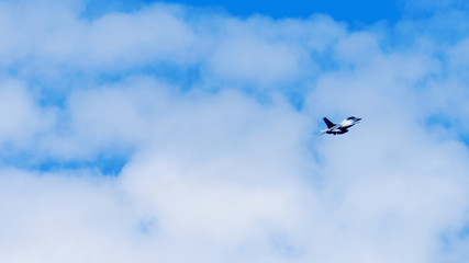 Military aircraft flying over blue