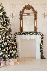 Christmas tree by the fireplace decorated with Christmas decorations