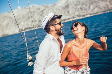 Couple in love on a sail boat in the summer.
