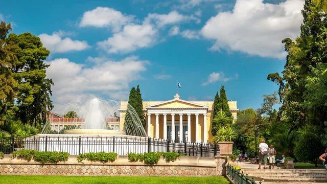 Zappeion building in National Gardens of Athens, Greece. Neoclassical architecture. White clouds move across the blue sky. Time lapse video.