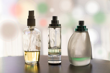 Three various half full perfume bottles