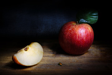 Fresh red apple on rustic background